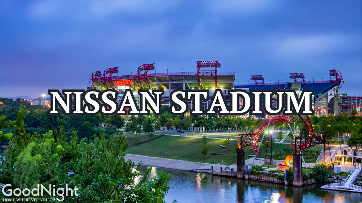 The exterior of Nissan Stadium with the riverfront park in the foreground and the urban Nashville landscape behind. People are visible enjoying the outdoor space, highlighting the stadium's vibrant location.