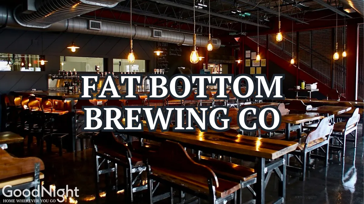 The interior scene features long wooden tables and a cozy bar, with warm lighting and an inviting atmosphere. This lively, communal space is ideal for socializing, hosting informal meetings, or sampling a flight of craft beers with colleagues.